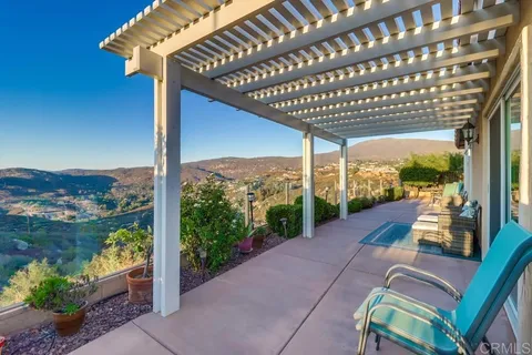 a view of a swimming pool with outdoor seating and plants