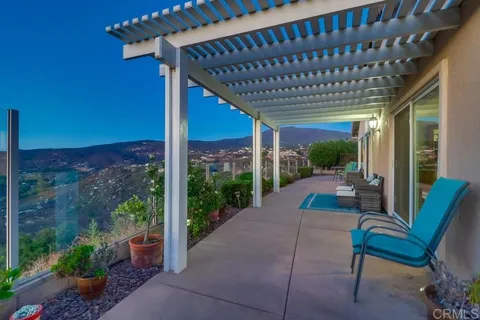 a view of a patio with couches and potted plants