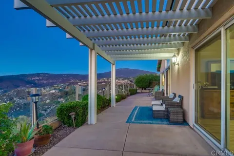 a view of a porch with furniture and garden