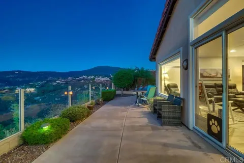 a view of a patio with couches and table and chairs and potted plants