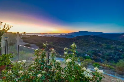 a view of a lush green hillside and a houses