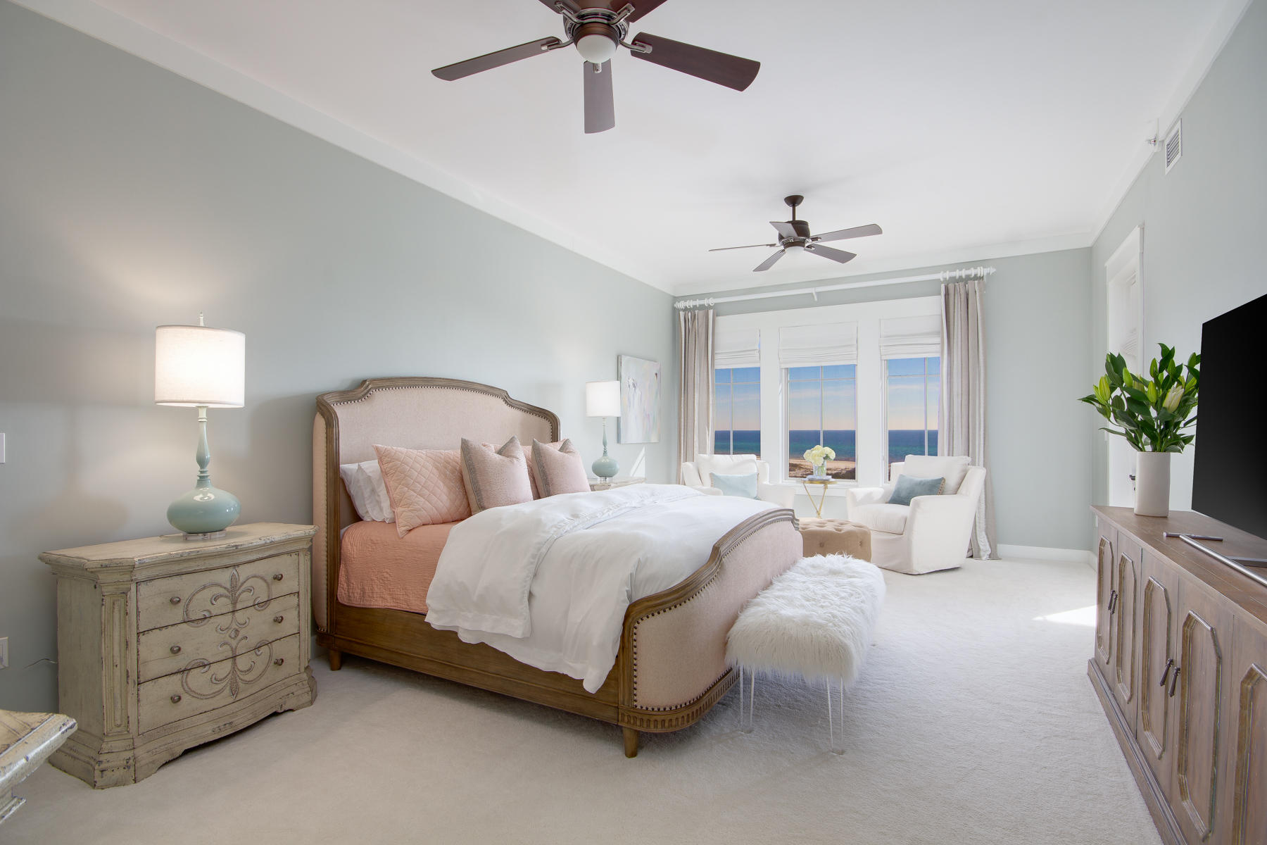 37 Compass Point, Unit 425 Watersound, FL 32461 - Photo 5 of 17 a spacious bedroom with a bed a chandelier and a window