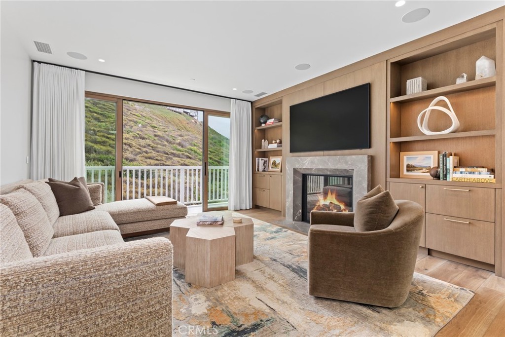 1 Beach View Avenue Dana Point, CA 92629 - Photo 17 of 42 a living room with fireplace furniture and a flat screen tv