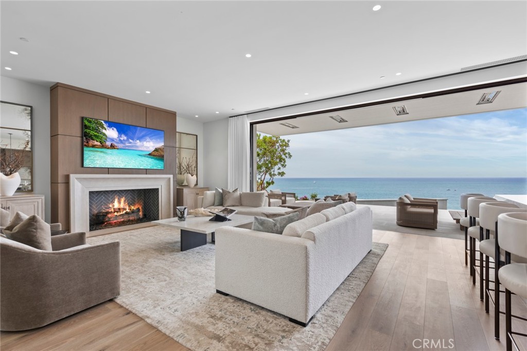 1 Beach View Avenue Dana Point, CA 92629 - Photo 2 of 42 a living room with furniture a flat screen tv and a fireplace