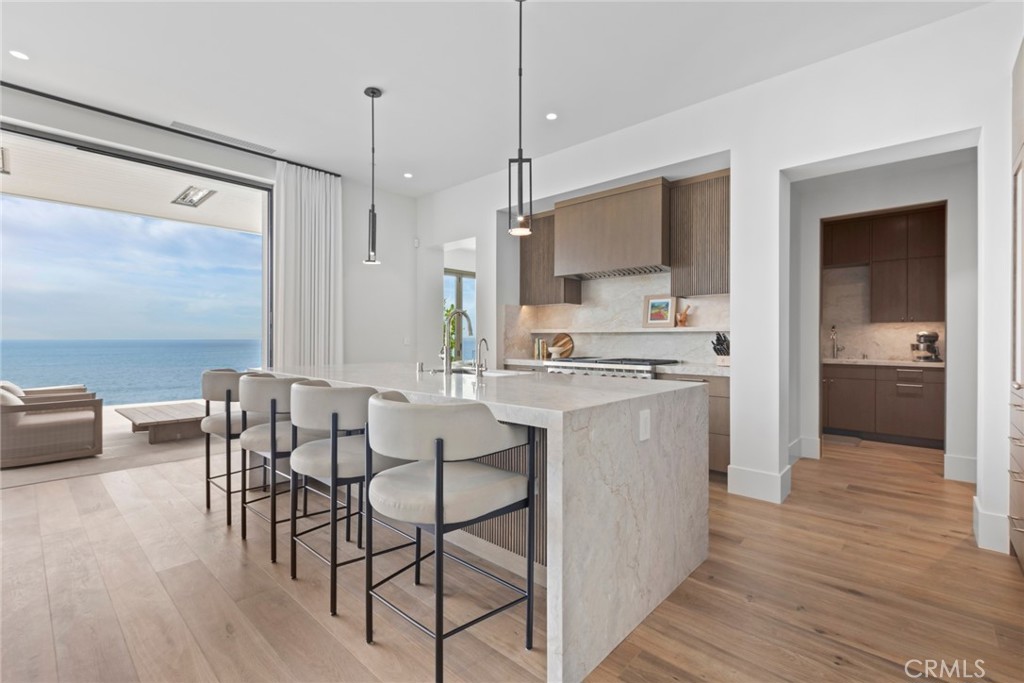 1 Beach View Avenue Dana Point, CA 92629 - Photo 8 of 42 a kitchen with a table chairs refrigerator and cabinets