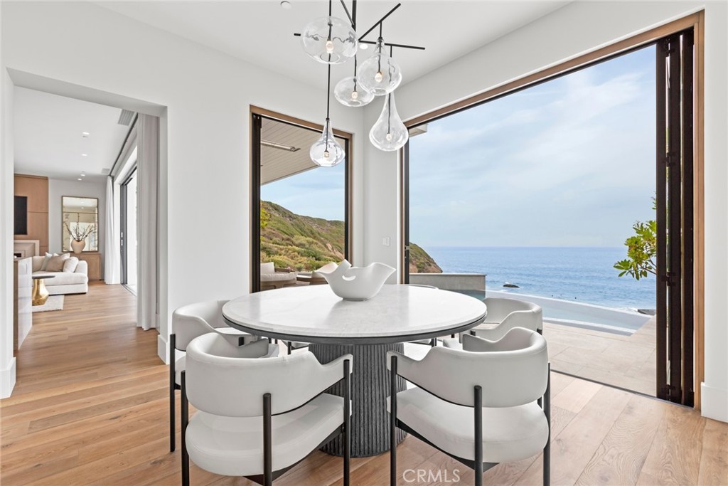 1 Beach View Avenue Dana Point, CA 92629 - Photo 10 of 42 a dining room with furniture a chandelier and wooden floor