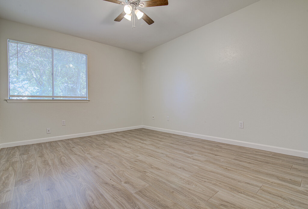 5301 Indio Circle, Unit A Austin, TX 78745 - Photo 15 of 25 A well-lit room showcases durable laminate flooring, offering comfort and style.