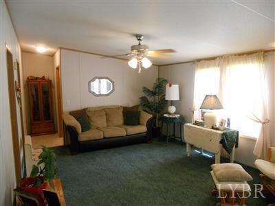 337 Phoebe Pond Road Concord, VA 24538 - Photo 11 of 19 a living room with furniture and a chandelier