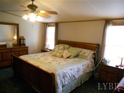 337 Phoebe Pond Road Concord, VA 24538 - Photo 13 of 19 a bedroom with a bed and a chandelier