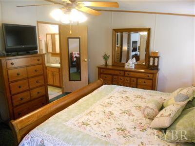 337 Phoebe Pond Road Concord, VA 24538 - Photo 14 of 19 a bedroom with a bed and a flat screen tv in it