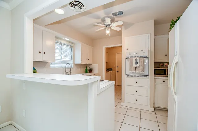 a kitchen with stainless steel appliances a refrigerator and cabinets