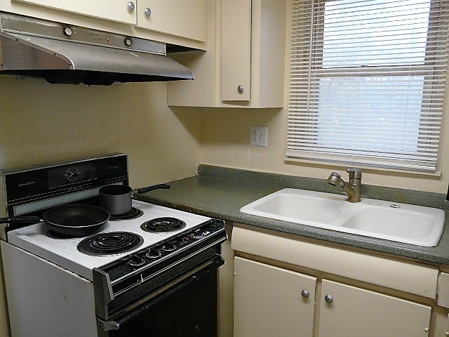 28459 Valley Road Ingleside, IL 60041 - Photo 7 of 11 a white stove top oven sitting inside of a kitchen