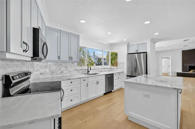 a view of a hallway with wooden floor and closet
