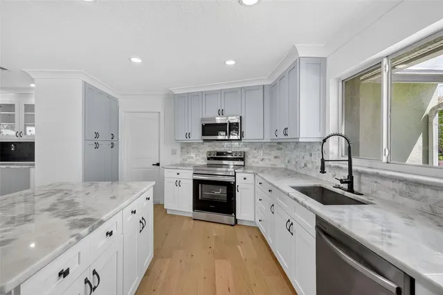 a large bathroom with a granite countertop double vanity sink and a mirror