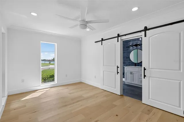 a bathroom with a toilet sink vanity granite and mirror