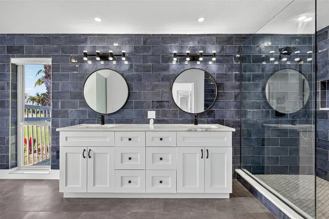 a bathroom with a granite countertop shower