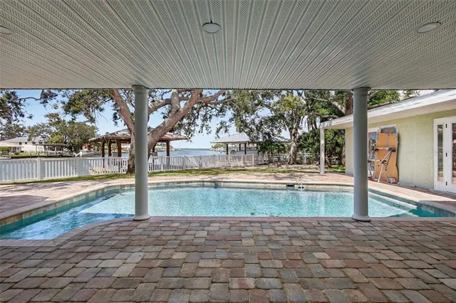 an aerial view of a house with outdoor space and a lake view