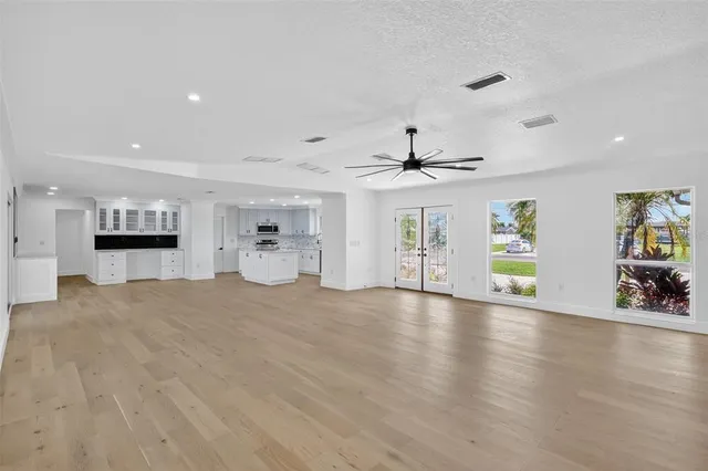 a kitchen with stainless steel appliances granite countertop a stove a refrigerator a sink and a microwave