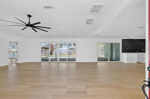 a kitchen with granite countertop a sink stove and refrigerator