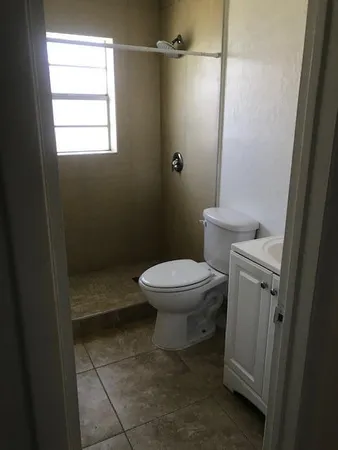 a bathroom with a toilet and a shower