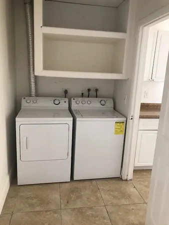 a kitchen with granite countertop a refrigerator and a stove