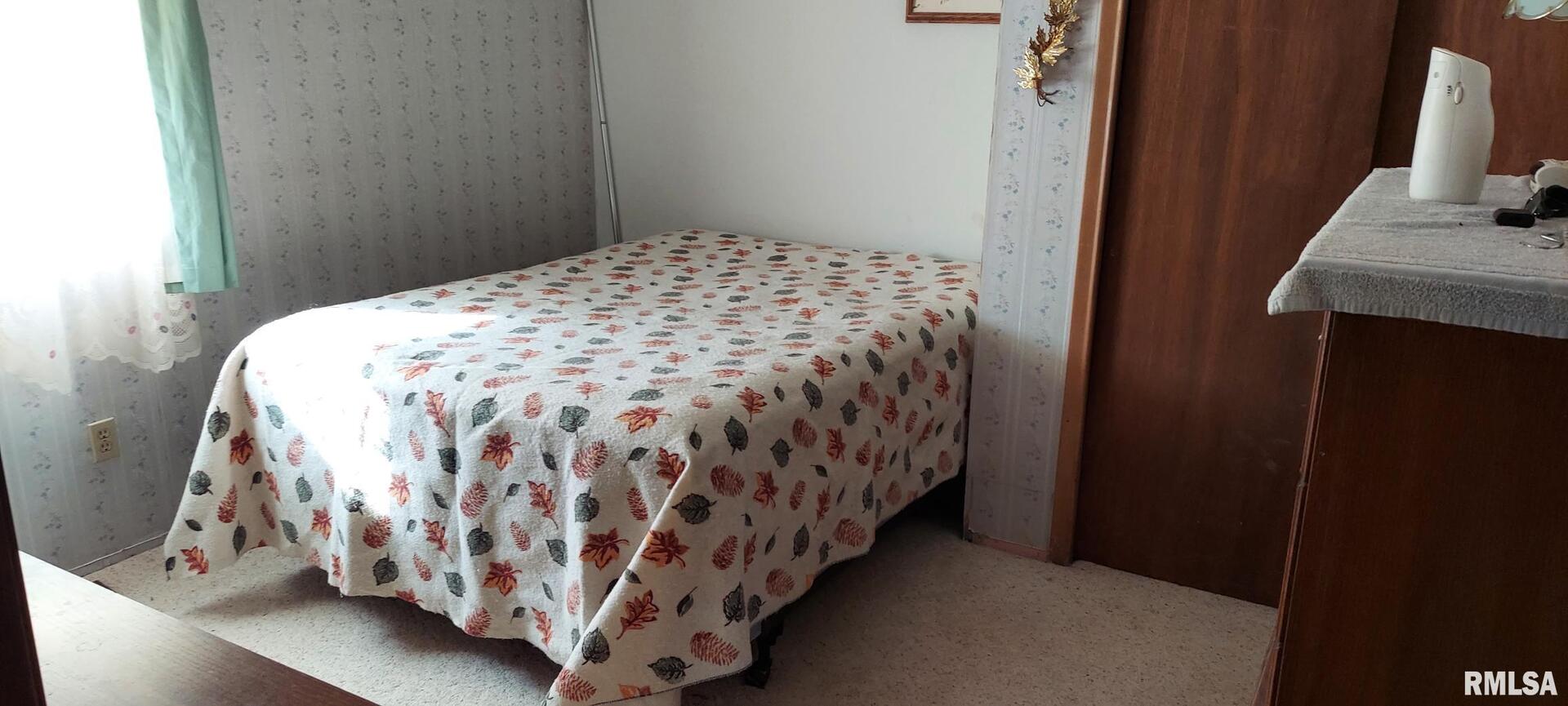 862 270th Street Viola, IL 61486 - Photo 14 of 17 a bed sitting in a bedroom next to a window