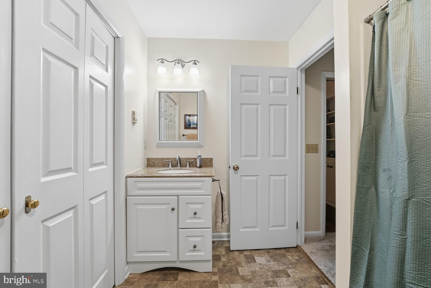 814 Wrights Neck Road Centreville, MD 21617 - Photo 39 of 53 a bathroom with a granite countertop sink and a mirror