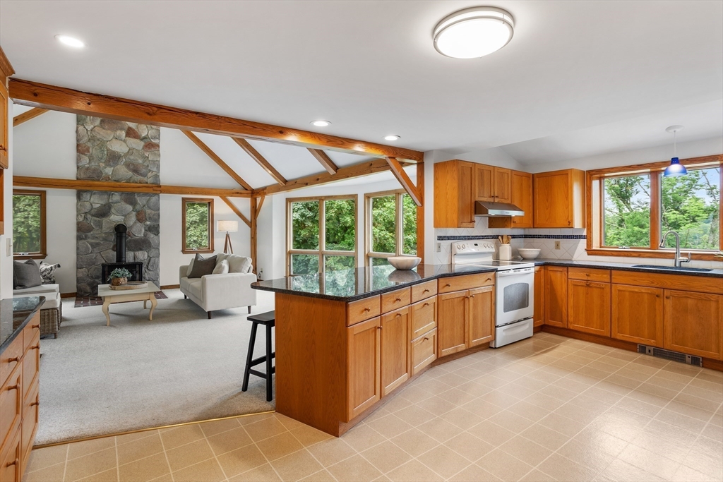 444 Middle Road Boxborough, MA 01719 - Photo 11 of 42 a large kitchen with stainless steel appliances granite countertop a large window and a counter space