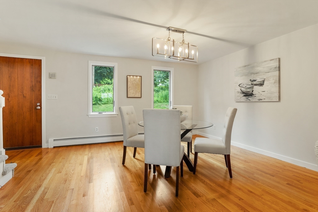 444 Middle Road Boxborough, MA 01719 - Photo 15 of 42 a view of a dining room with furniture a chandelier and wooden floor