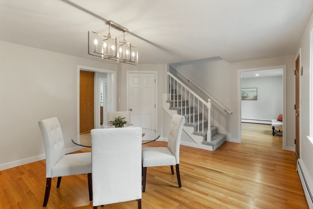 444 Middle Road Boxborough, MA 01719 - Photo 16 of 42 a view of a dining room with furniture a chandelier and wooden floor