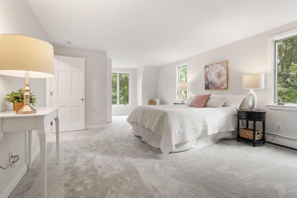 444 Middle Road Boxborough, MA 01719 - Photo 20 of 42 a spacious bedroom with a bed and a window