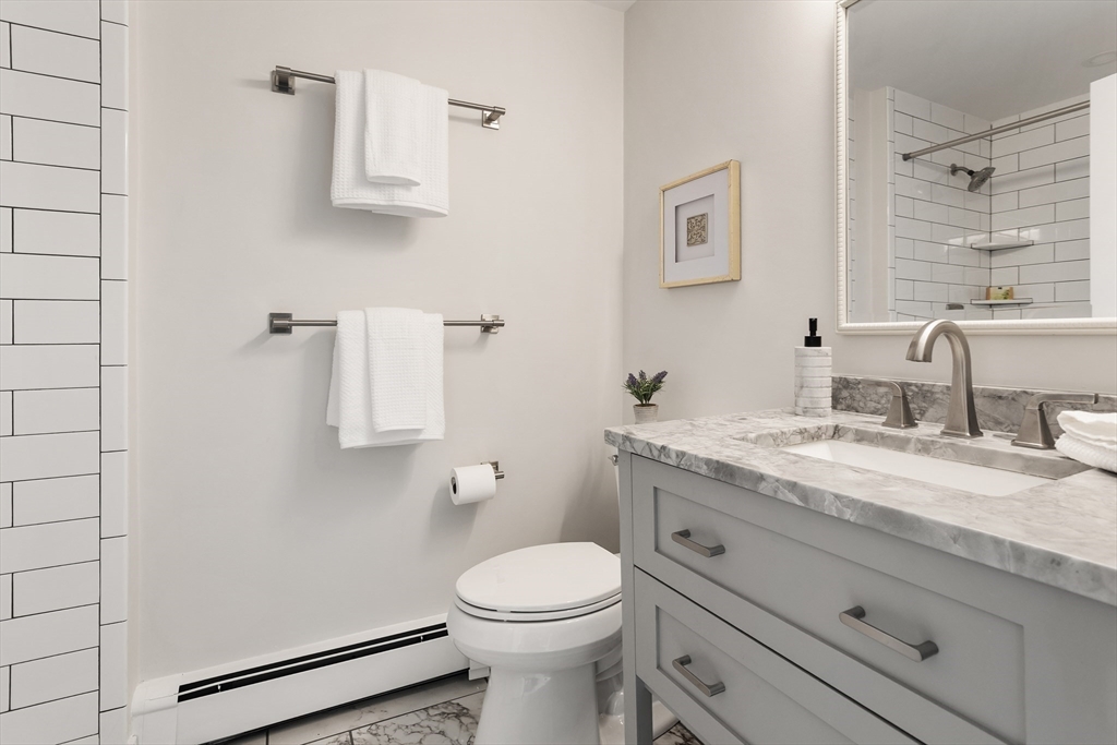 444 Middle Road Boxborough, MA 01719 - Photo 21 of 42 a bathroom with a granite countertop toilet sink and mirror