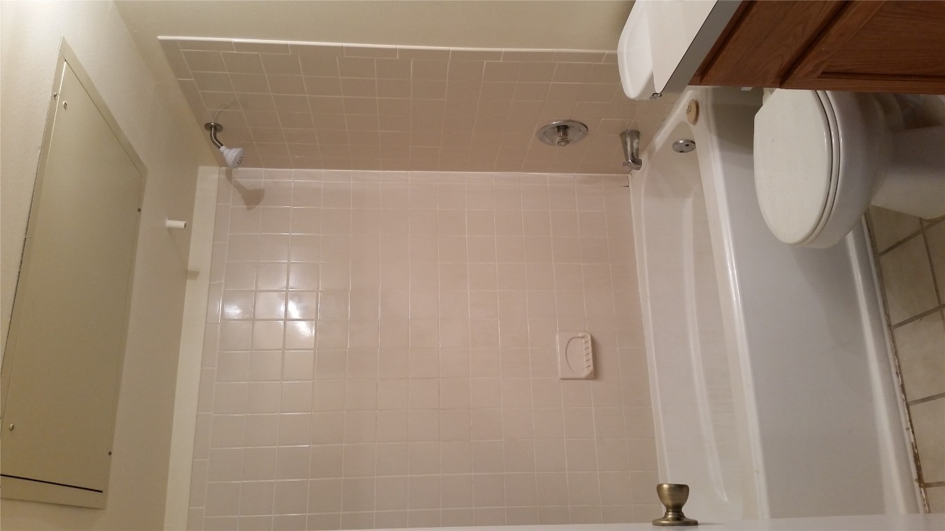 6809 West Gate Boulevard, Unit 203 Austin, TX 78745 - Photo 11 of 12 Full bathroom with shower / bath combination, light tile patterned floors, and vanity