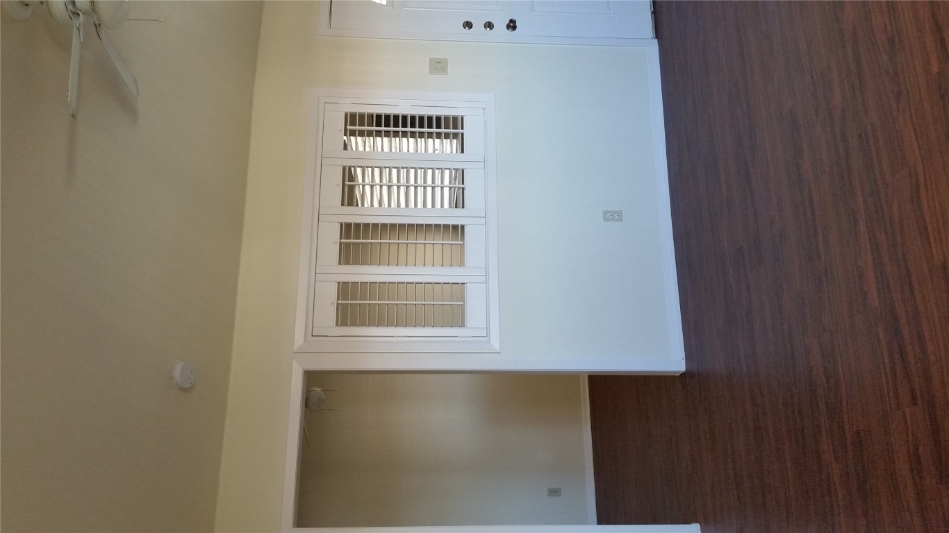 6809 West Gate Boulevard, Unit 203 Austin, TX 78745 - Photo 9 of 12 Spare room with dark wood-style flooring and ceiling fan