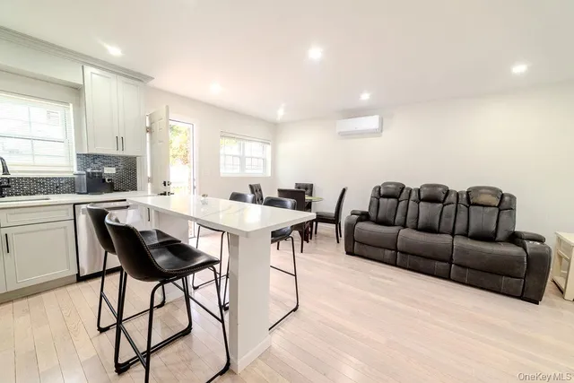 a kitchen with stainless steel appliances white cabinets granite counter tops and a window