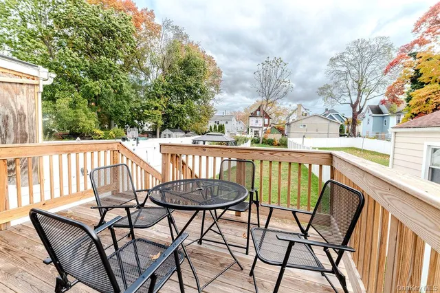 a view of a chairs and table on the balcony