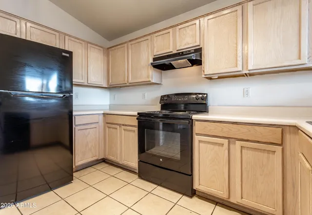 a kitchen with stainless steel appliances granite countertop a stove a refrigerator and a microwave