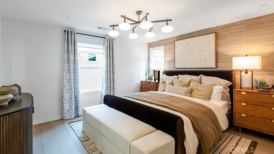 1676 Phantom Lane Rialto, CA 92376 - Photo 12 of 22 a bedroom with a bed and a chandelier