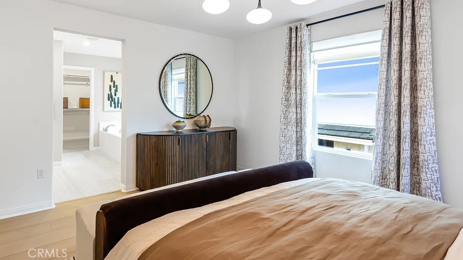 1676 Phantom Lane Rialto, CA 92376 - Photo 13 of 22 a bedroom with a bed a mirror and a window