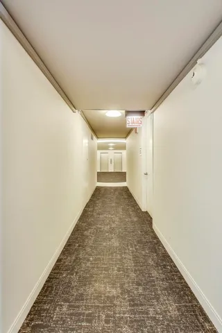 a view of a bathroom with a sink and a mirror