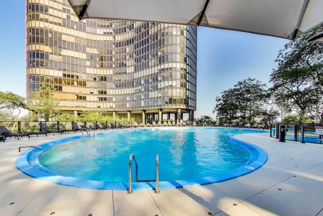 a view of a chairs and table in a backyard