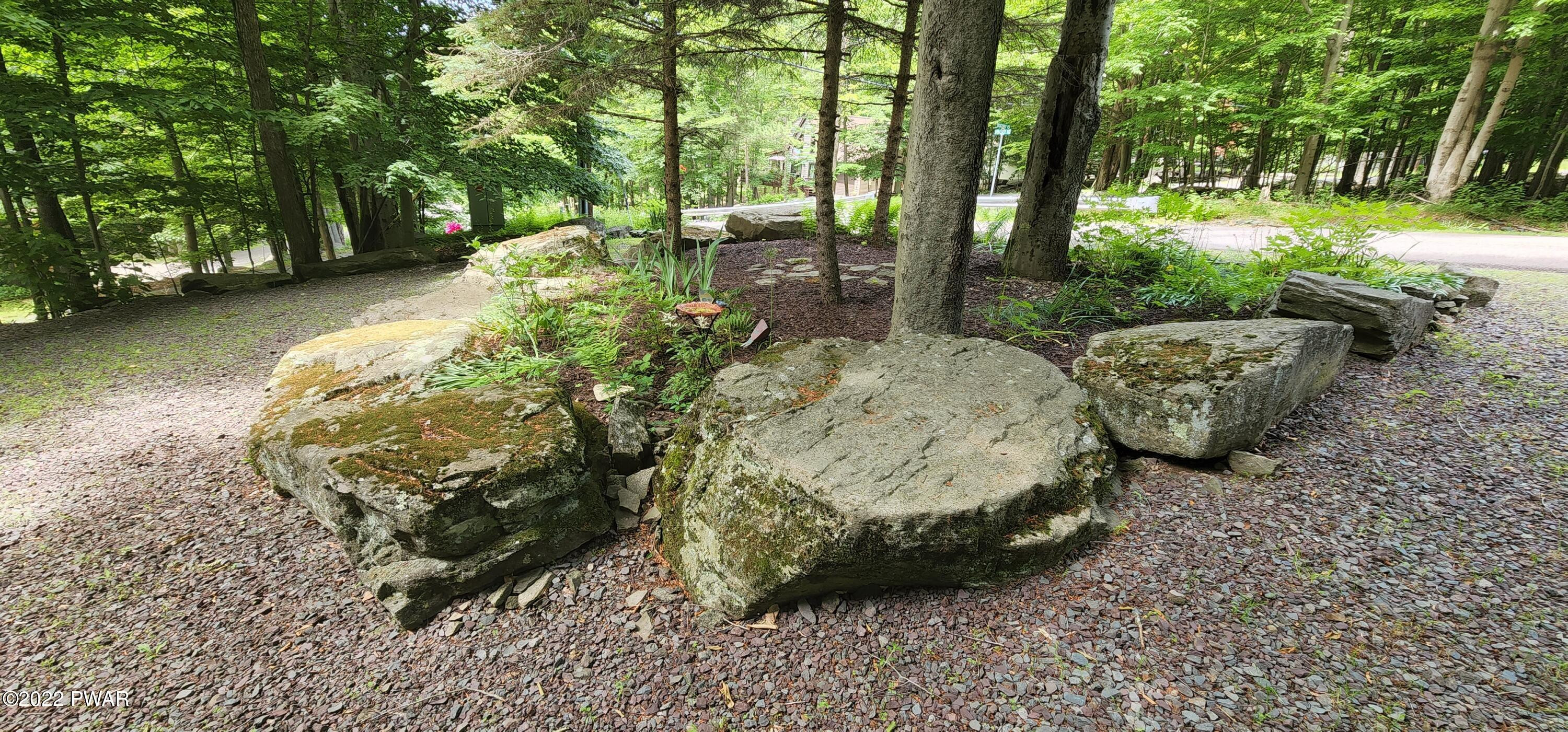 40 Boulder Road Lake Ariel, PA 18436 - Photo 7 of 52 a view of a backyard with table and chairs plants and large trees