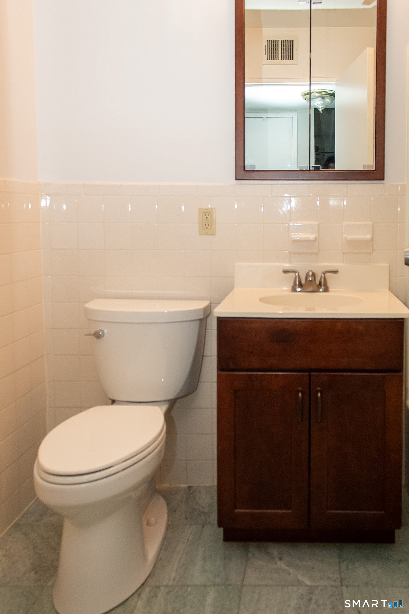 10 Georgetown Drive, Unit J Enfield, CT 06082 - Photo 7 of 15 a bathroom with a toilet a sink and mirror
