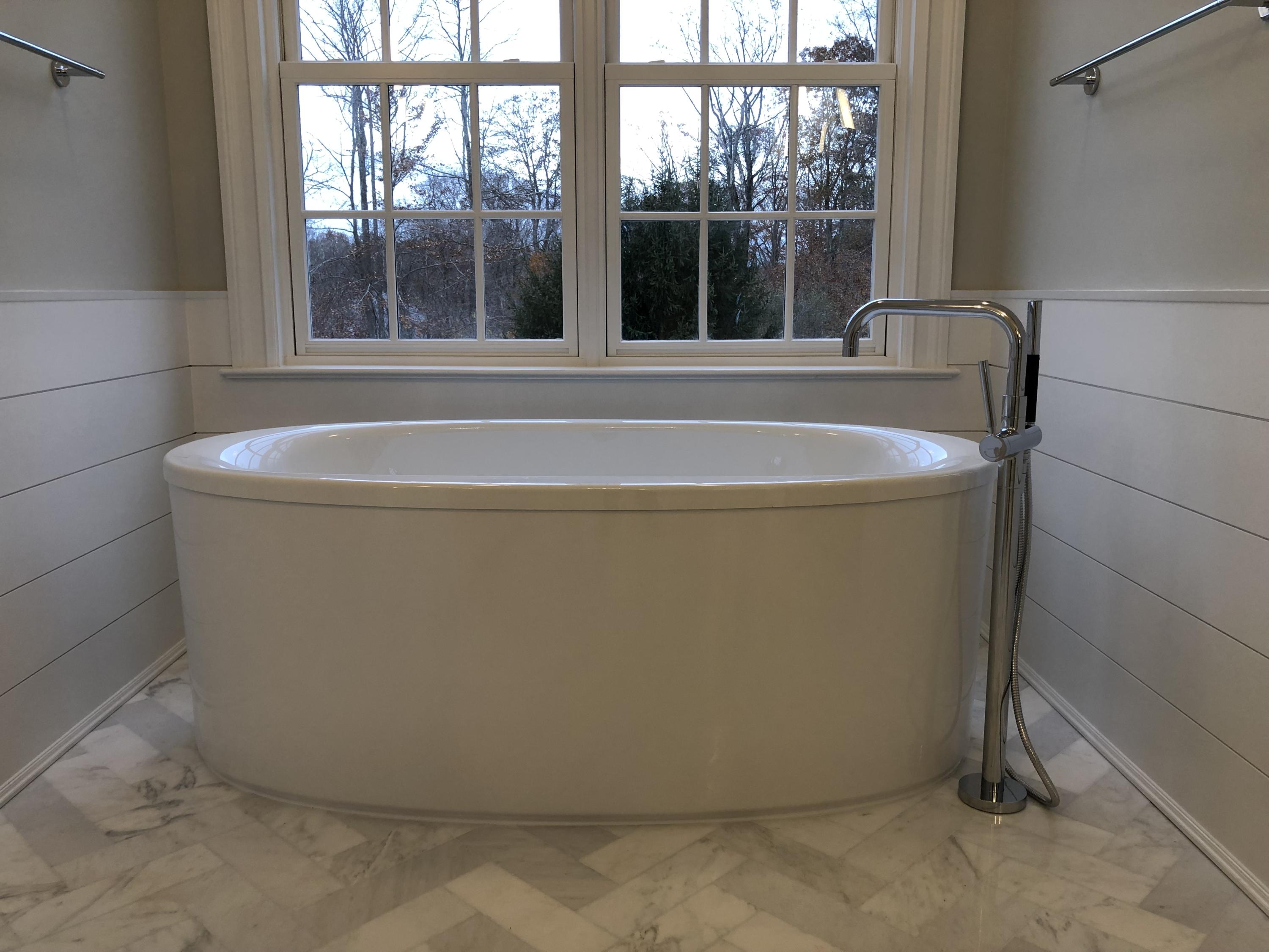 235 Cheese Spring Road Wilton, CT 06897 - Photo 29 of 55 a white bath tub sitting in a bathroom next to a window
