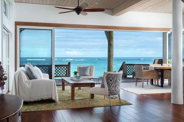 a living room with fireplace furniture and a large window