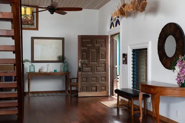a view of a chairs and table in the balcony