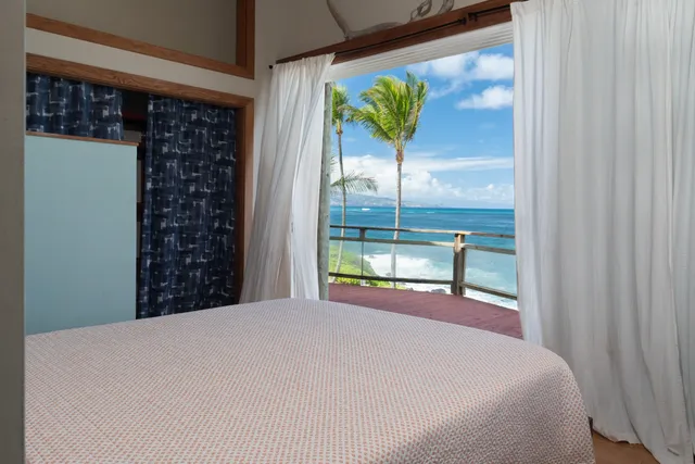 a view of a dining room with furniture and a potted plant
