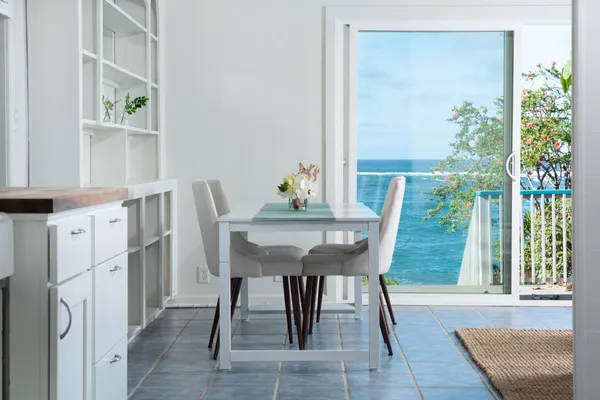 a dining room with furniture and a window