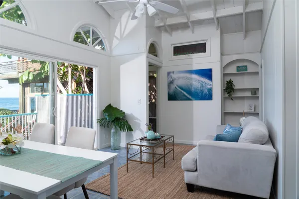a living room with furniture and a potted plant
