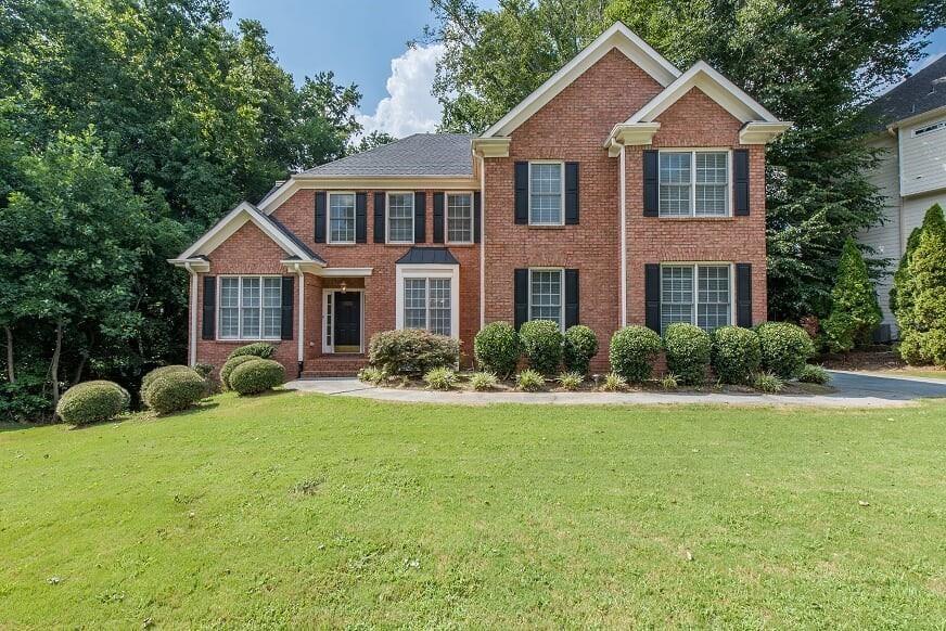 1017 Lansfaire Crossing Suwanee, GA 30024 - Photo 1 of 1 a front view of a house with a yard and porch